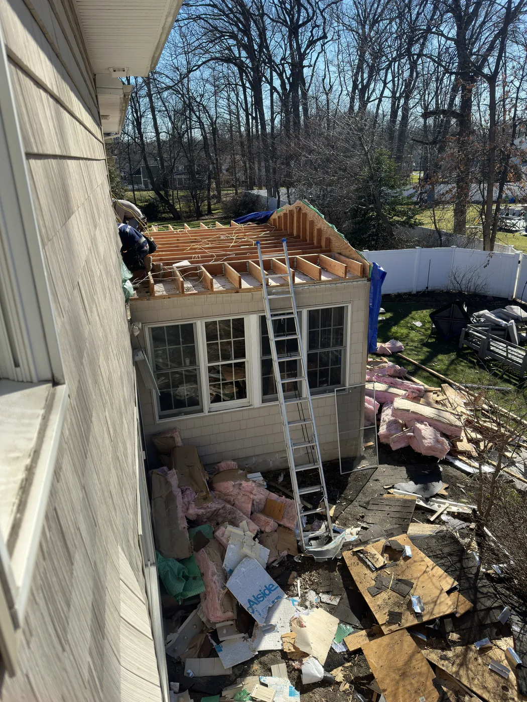 Open framing wrapped in weather-tight Tyvek shell — before